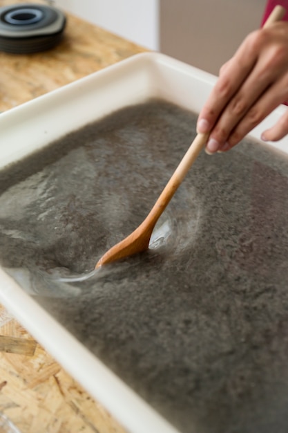 close-up-woman-s-hand-stirring-paper-pulp_23-2147845513 close-up-woman-s-hand-stirring-paper-pulp_23-2147845513