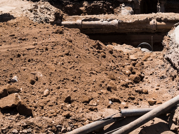 construction-site-with-old-pipes-dug-out_23-2148254078 construction-site-with-old-pipes-dug-out_23-2148254078