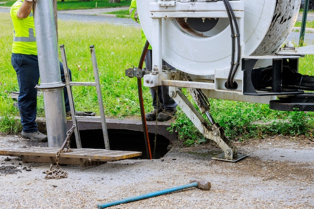 machine-cleaning-sewer-wells-town-street_73110-8295 machine-cleaning-sewer-wells-town-street_73110-8295