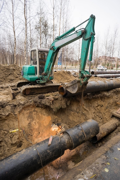 replacement-old-pipes-with-new-ones-welder-works-excavated-pit_73209-1127 replacement-old-pipes-with-new-ones-welder-works-excavated-pit_73209-1127