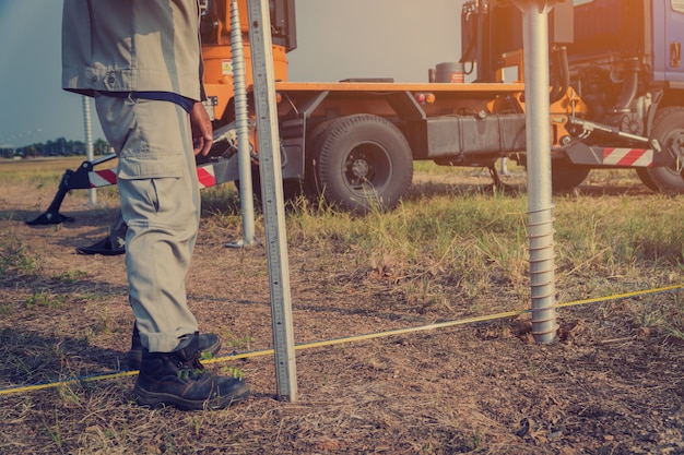 technician-installing-ground-screw-mounting-structure-solar-panel-solar-farm_41380-111 technician-installing-ground-screw-mounting-structure-solar-panel-solar-farm_41380-111